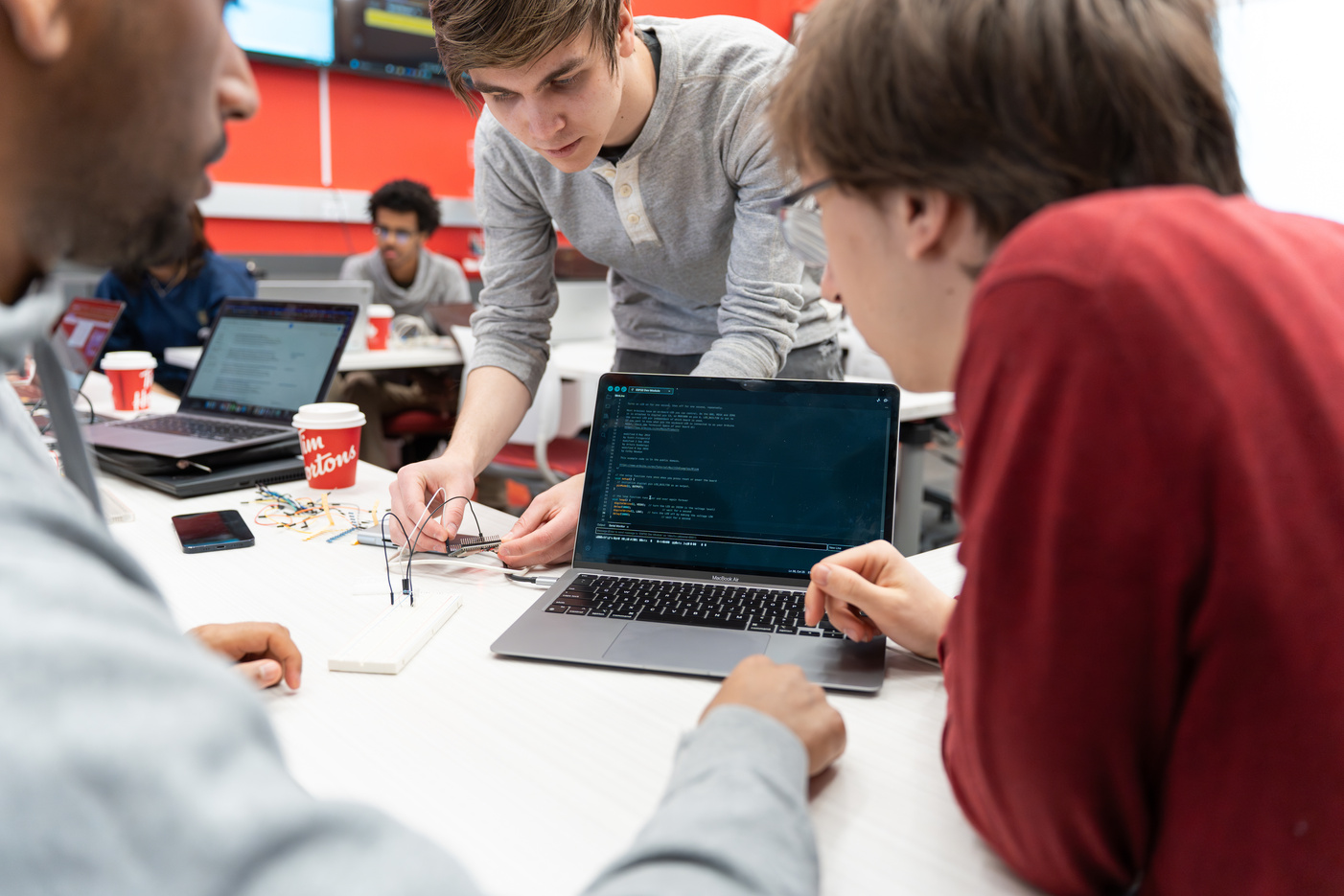 Students working on electronics and robotics code